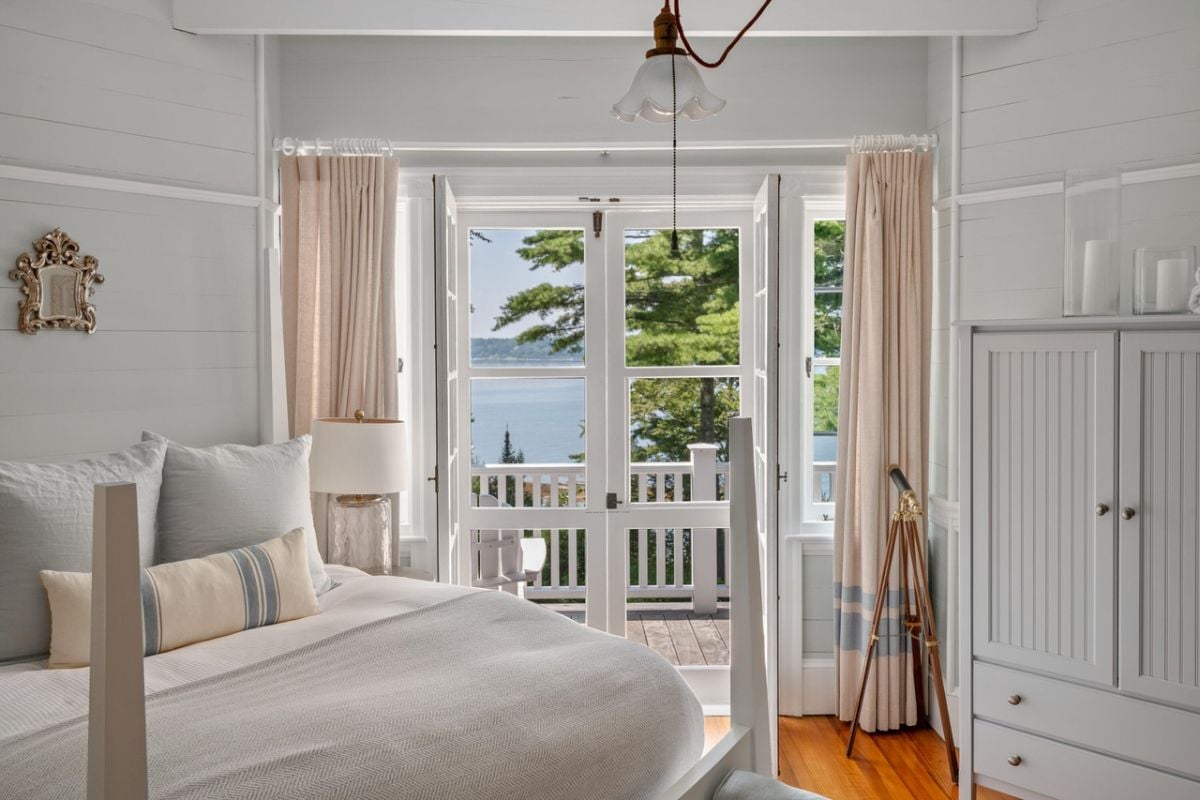 Bedroom with a large bed, glass door and custom cabinet.