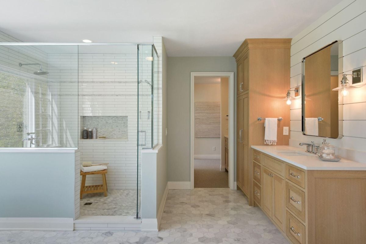 Bathroom with wooden vanity and a walk-in shower.