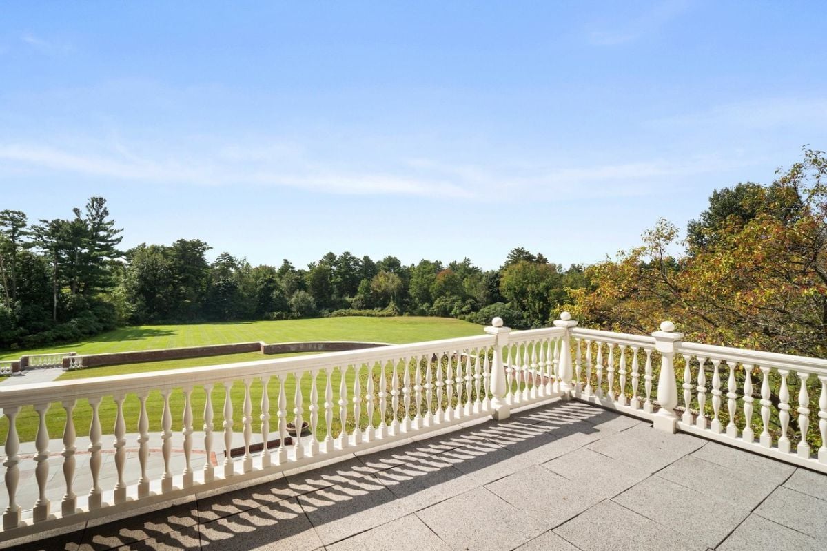Balcony overlooking the large green lawn.