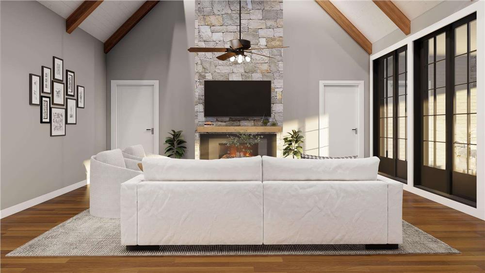 Great room with gray seats and a stone fireplace topped with a TV.