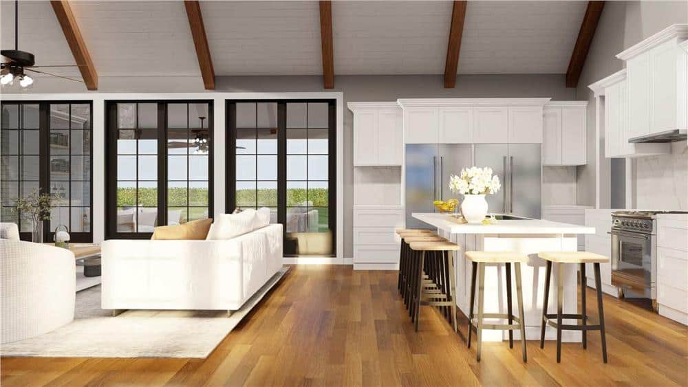 Great room and kitchen with hardwood flooring and a vaulted ceiling.