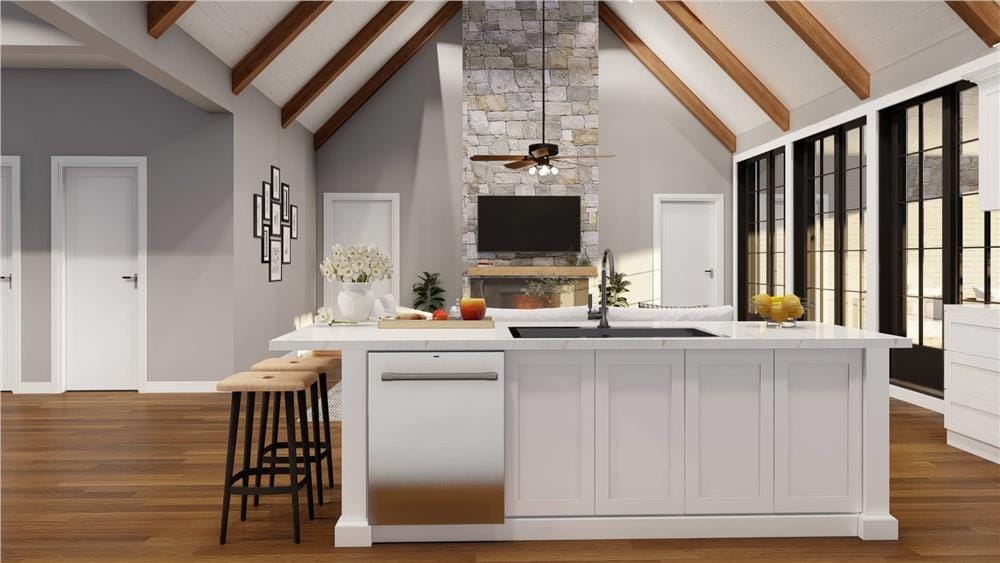 Kitchen island with a prep sink and dishwasher overlooking the great room.