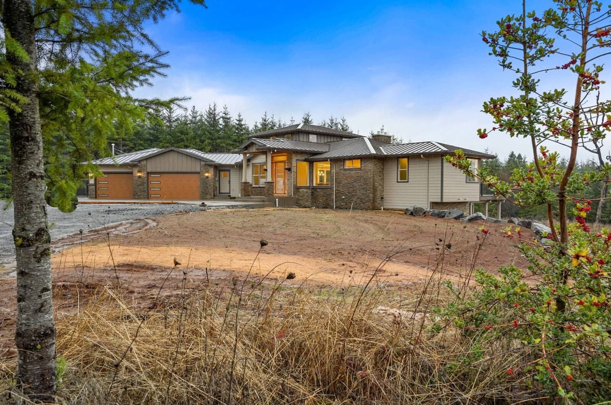 Front view of the house with a large front yard.