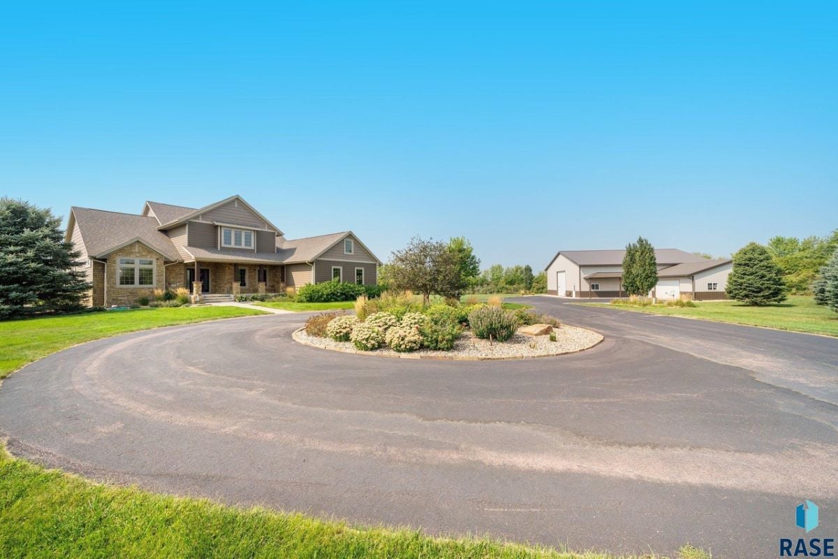 Front view of the house with a large driveway.