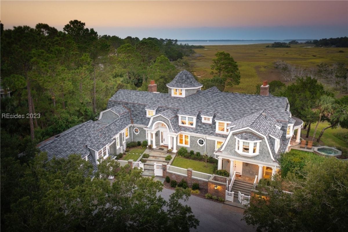 Aerial view of the mansion surrounded by trees.