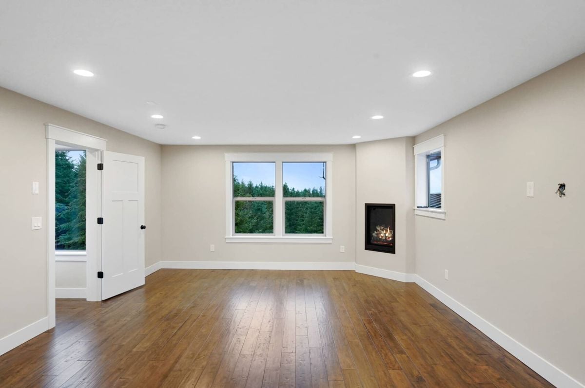 Bedroom with custom lights, glass windows and a fireplace.