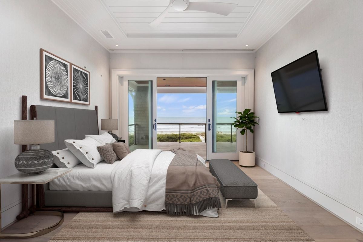 Bedroom with a large bed, a large rug and a balcony.