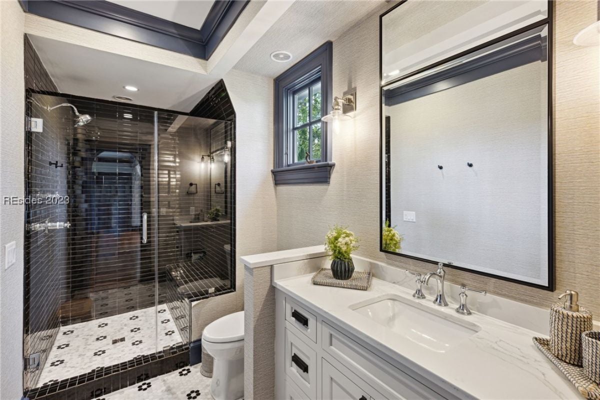 Bathroom with a sink, toilet and a walk-in shower.