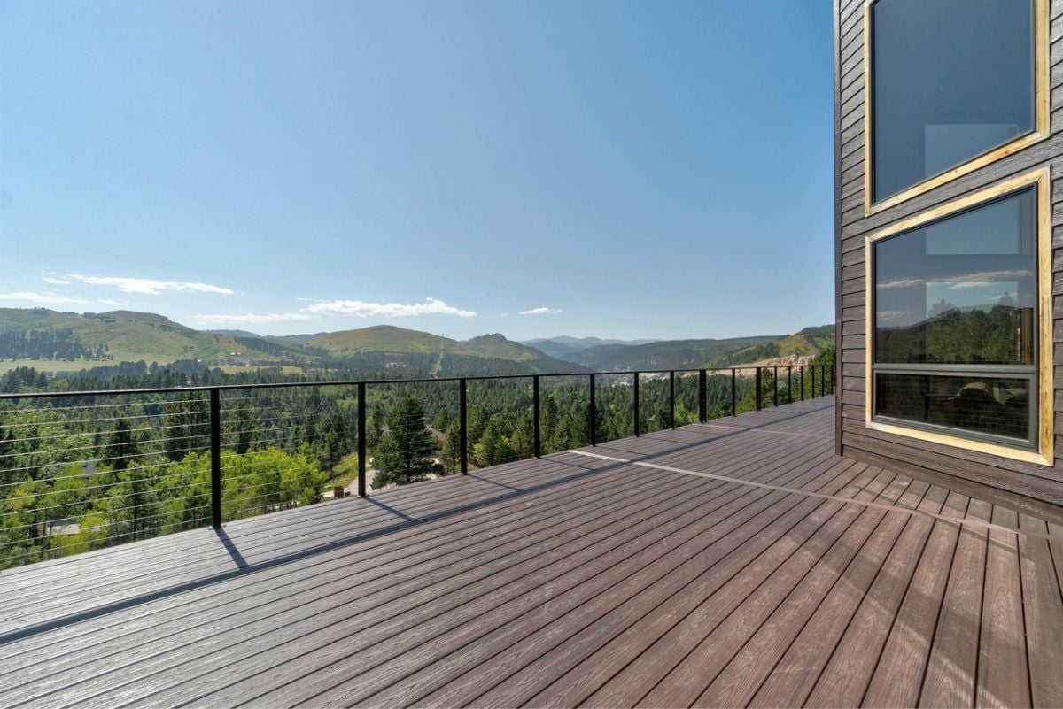 Balcony with metal railings and a view of the mountains.