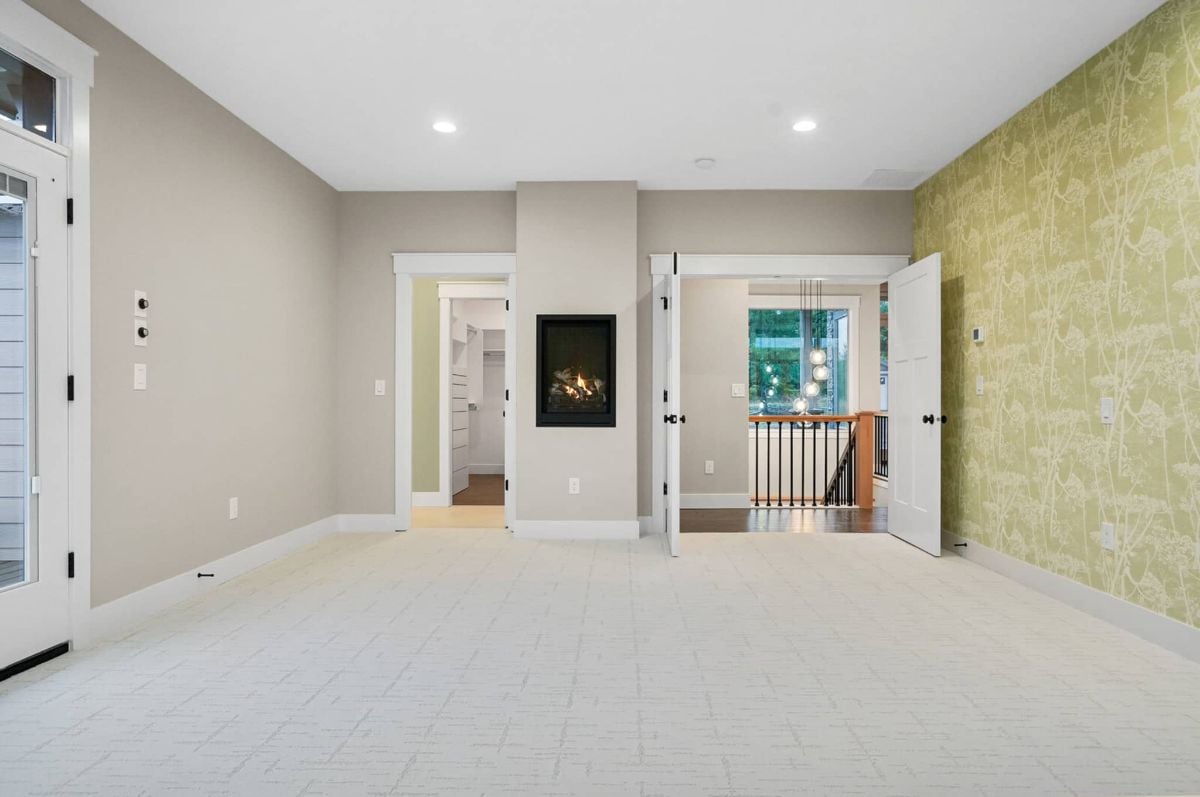 Bedroom with custom lights and a fireplace.