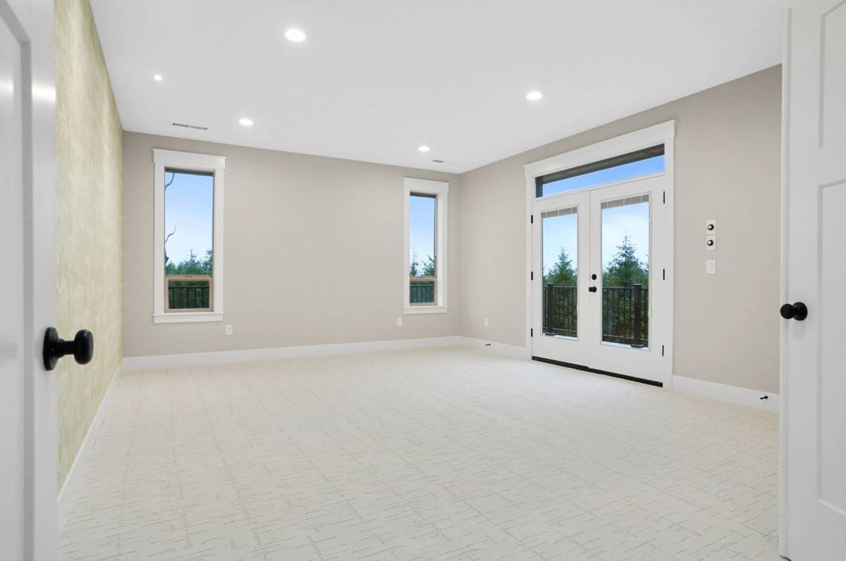 Bedroom with custom lights, glass windows and glass doors.