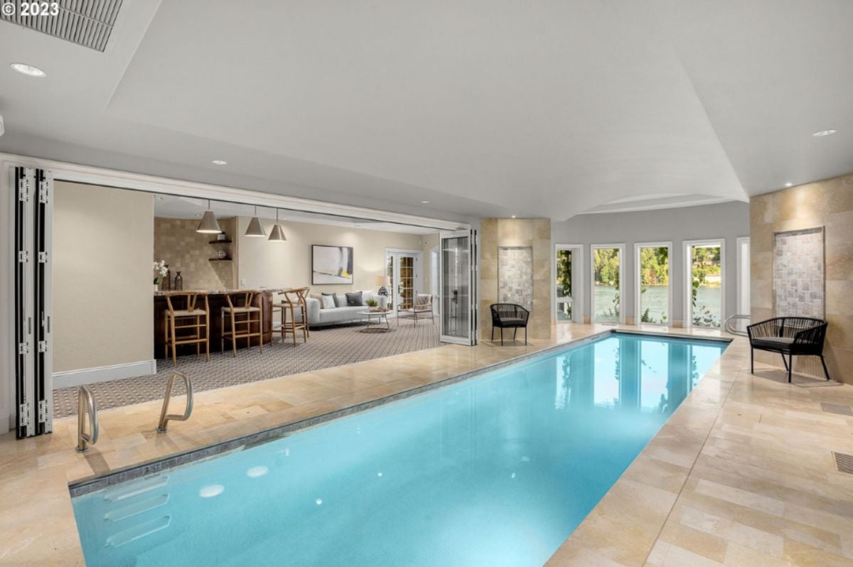 Indoor pool with a bar and a living room.