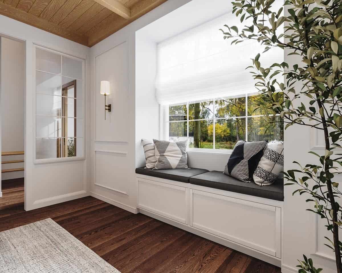 Window seat nook with leather cushions and patterned throw pillows.