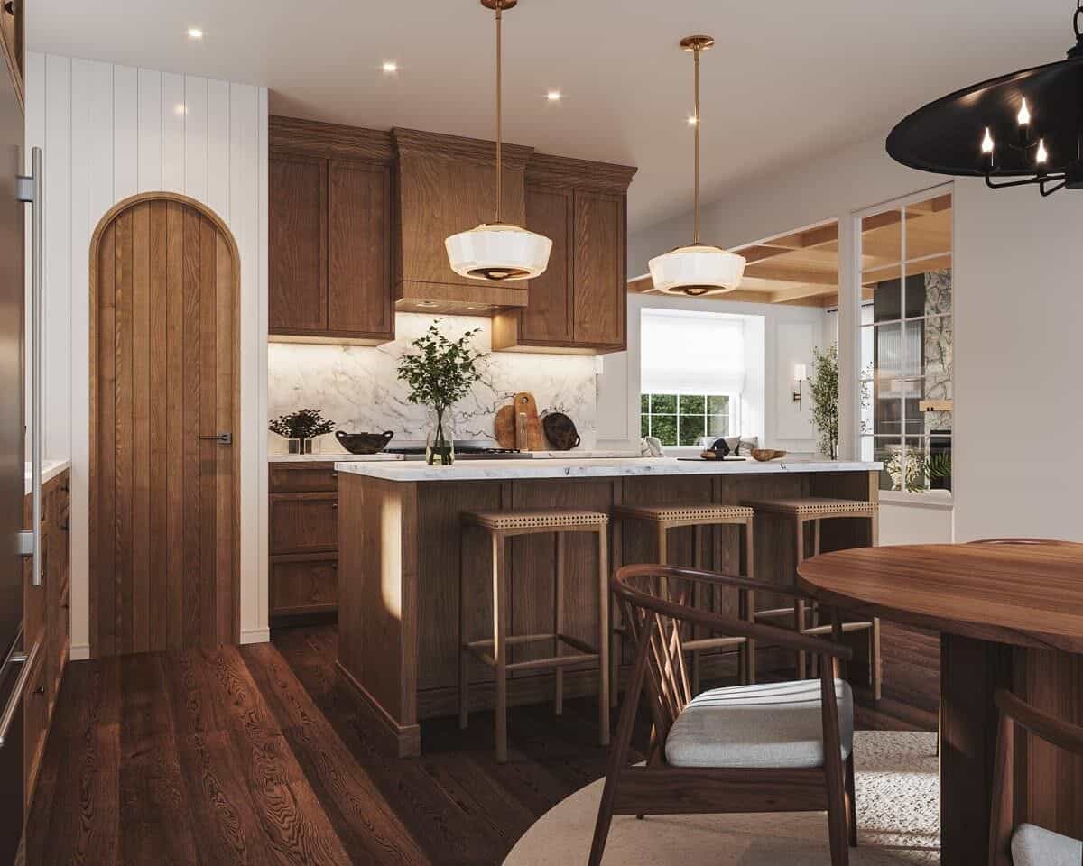 The kitchen includes a walk-in pantry concealed behind an arched door.