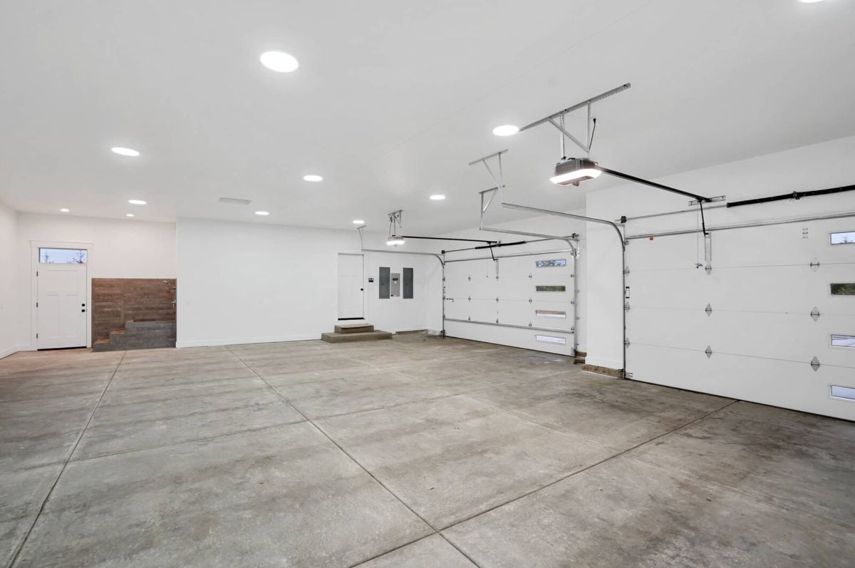 Spacious garage with custom lights and automatic garage door opener.