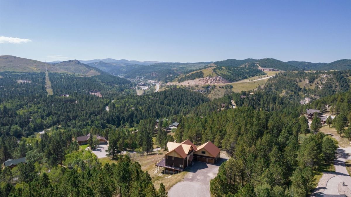 Aerial view of the property with a view of the mountains.