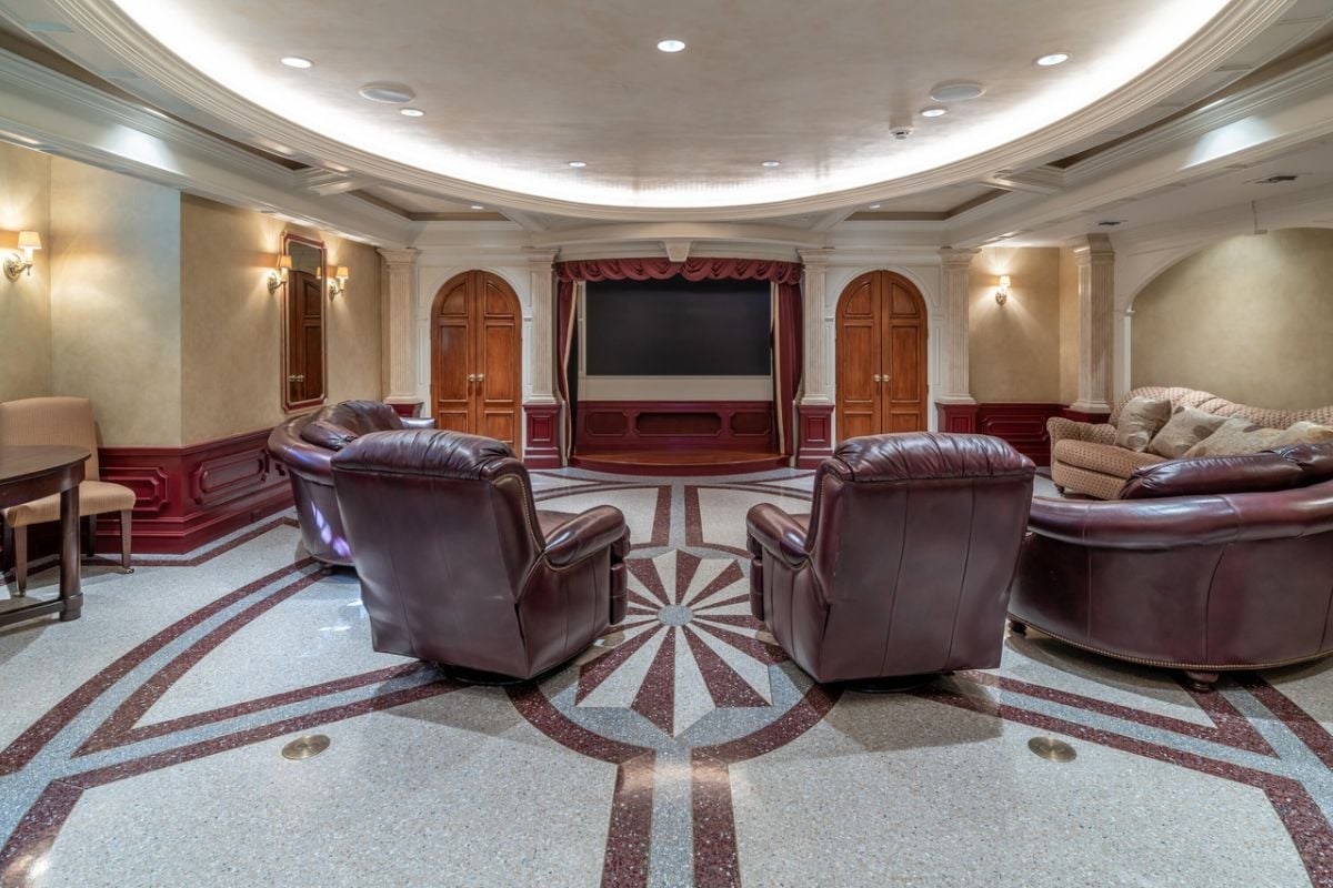 Home Theater with a large TV, custom lights, and couches.