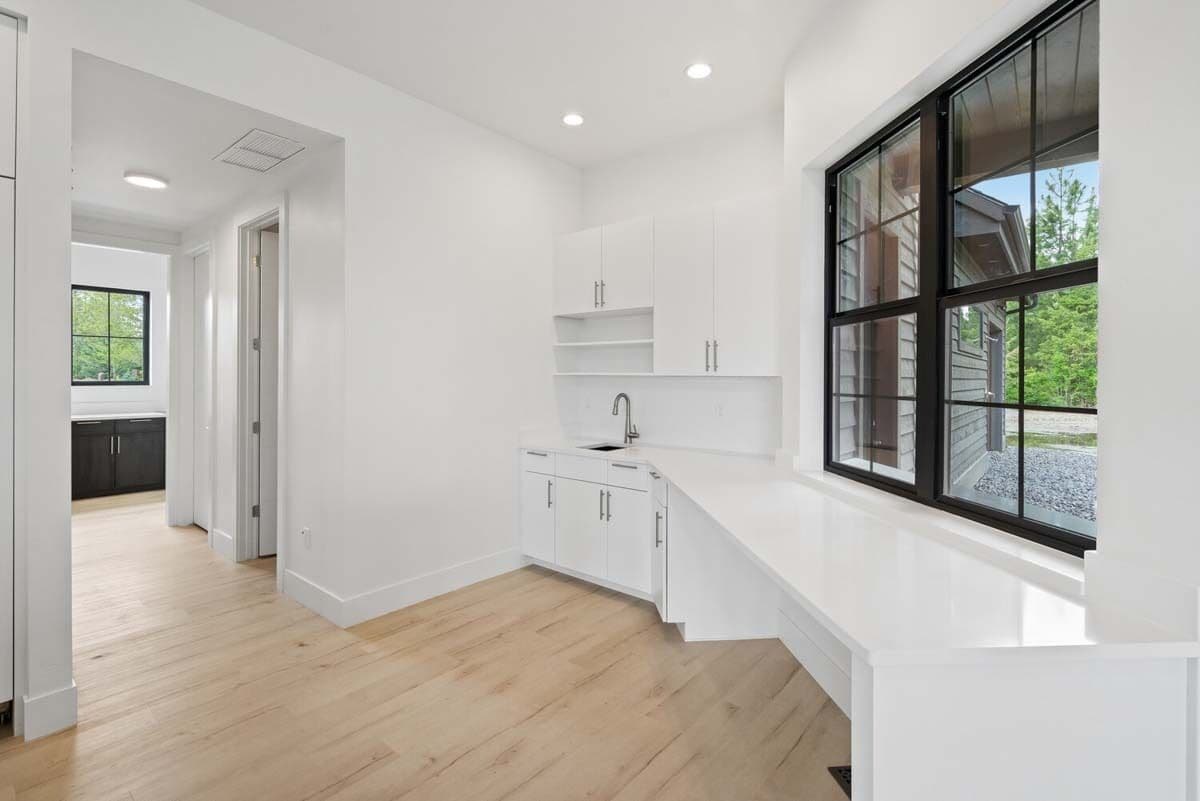 Laundry room with quartz countertops, a sink, and large windows that invite natural light in.