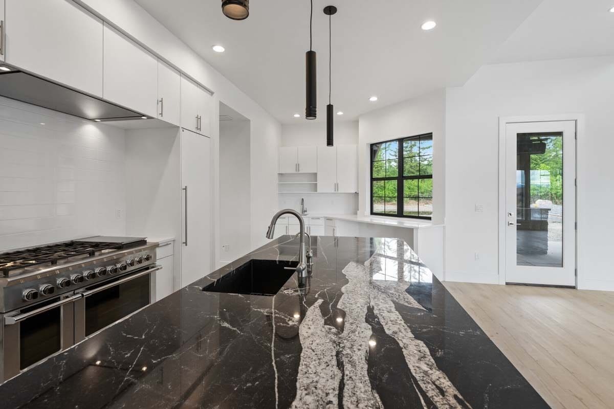 The kitchen includes a prep sink fitted on the center island.