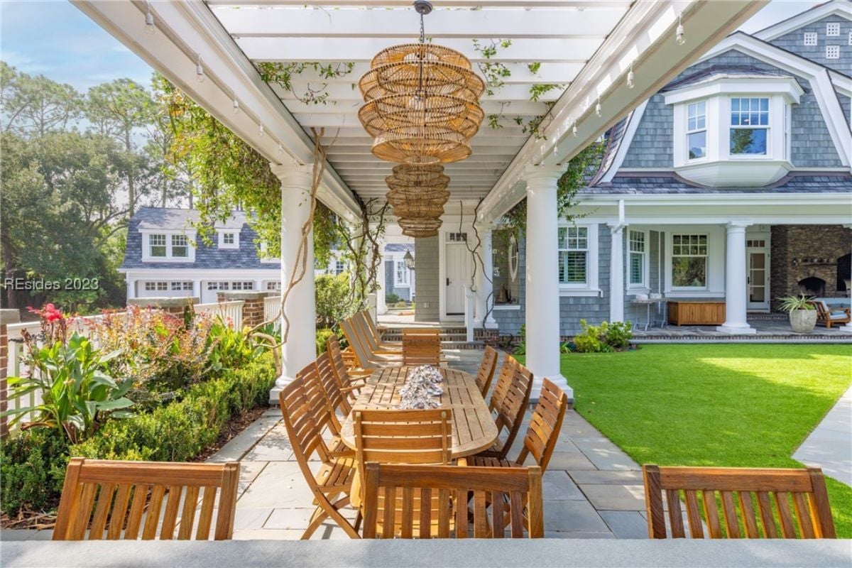 Pergola with a table and chairs.