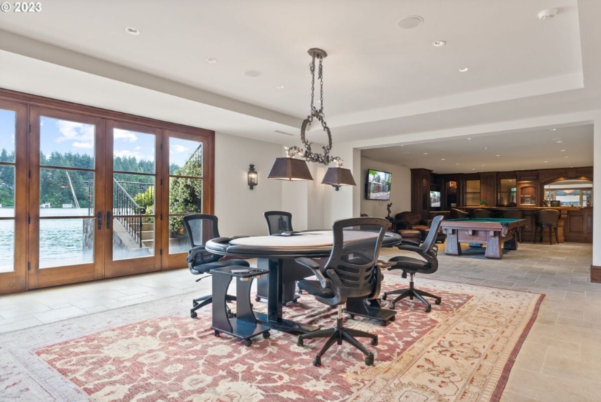 Recreation room with billiards table, bar and chandelier.