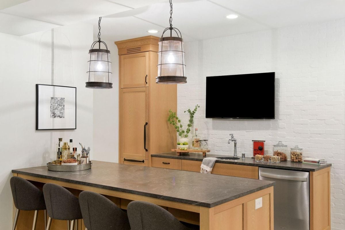 Bar with chairs, TV, custom cabinet and custom lights.