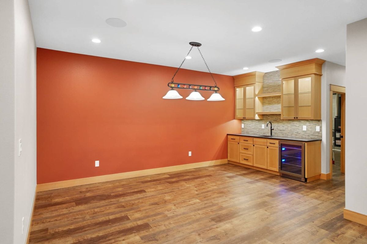 Game room with custom lights, custom cabinetry and a sink.