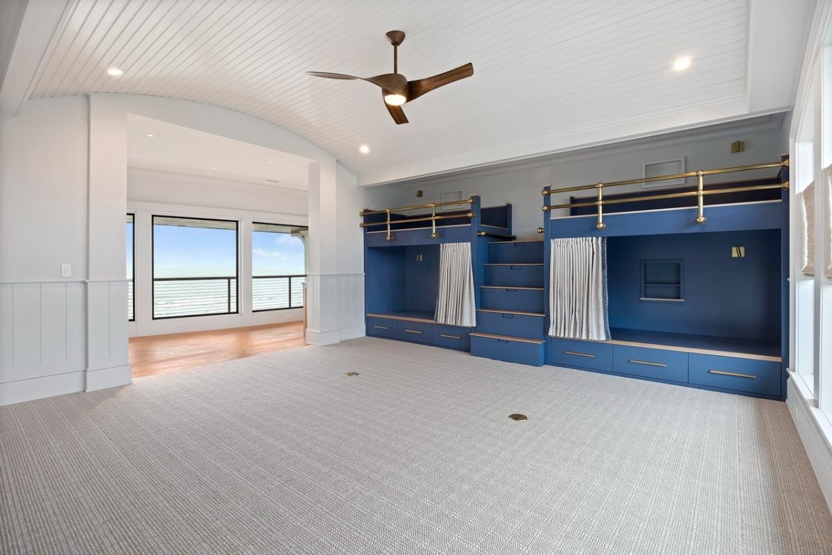 Bedroom with carpet flooring, bunks and custom lights.