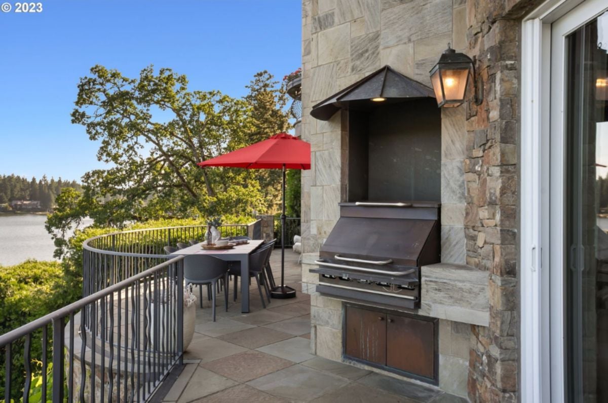 Patio with a grill area overlooking the lake.