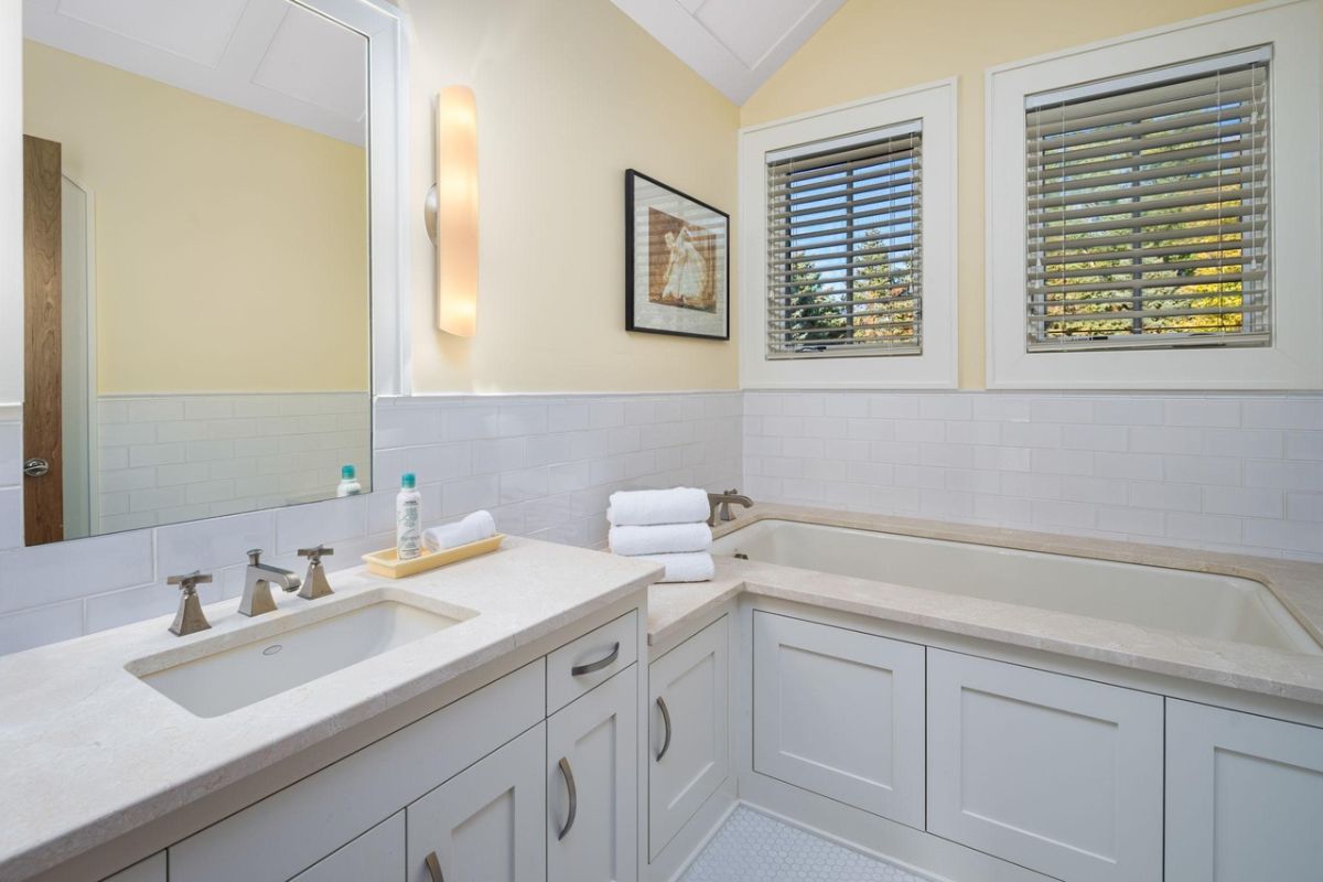 Bathroom with a sink, mirror and a soaking tub.
