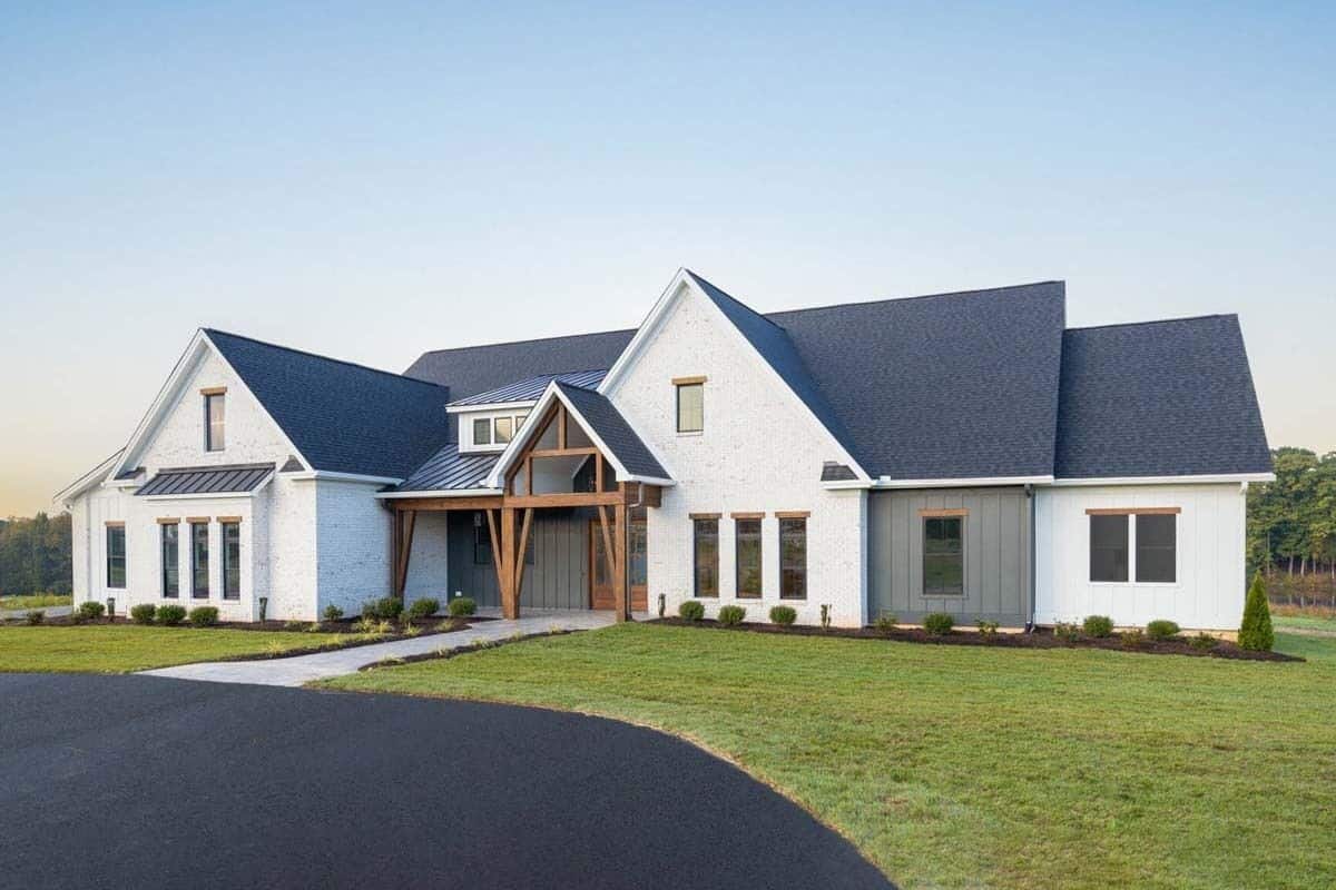 Front-right view with multiple gables and a covered entry porch framed with rustic timbers.