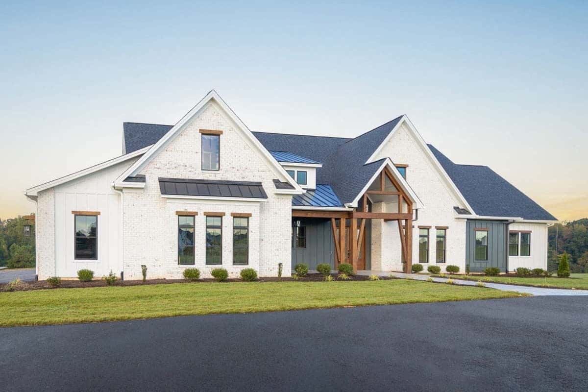 Front-left view with a covered entry porch and a side-entry garage.