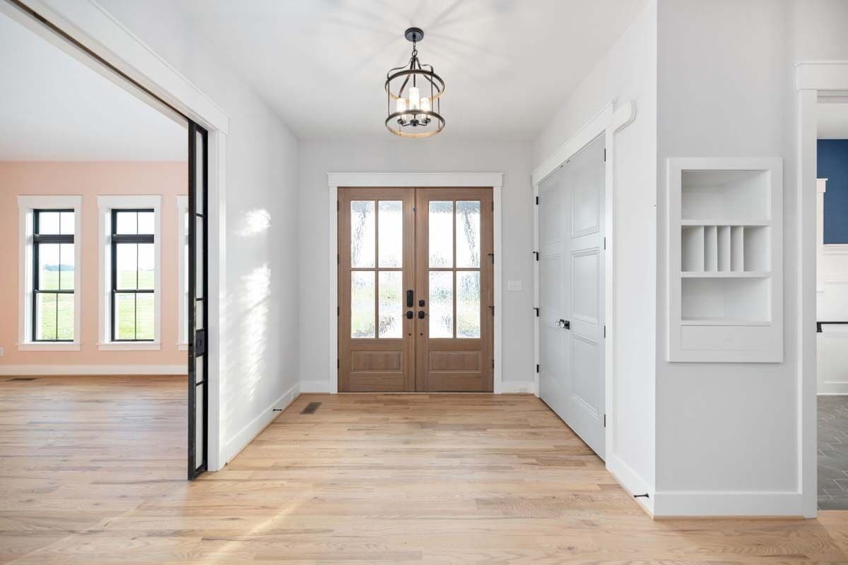 Foyer with a French front door and a hardwood flooring.