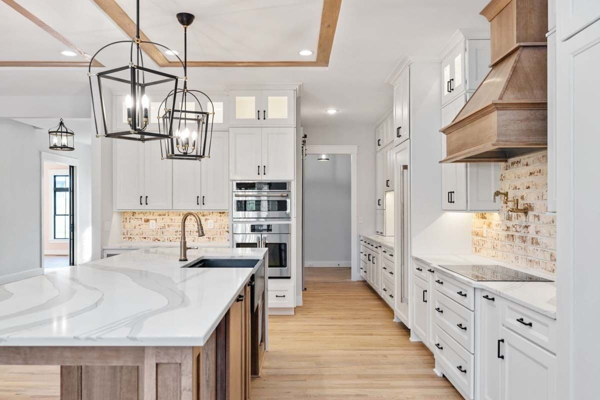 The kitchen includes marble countertops and brick backsplashes.