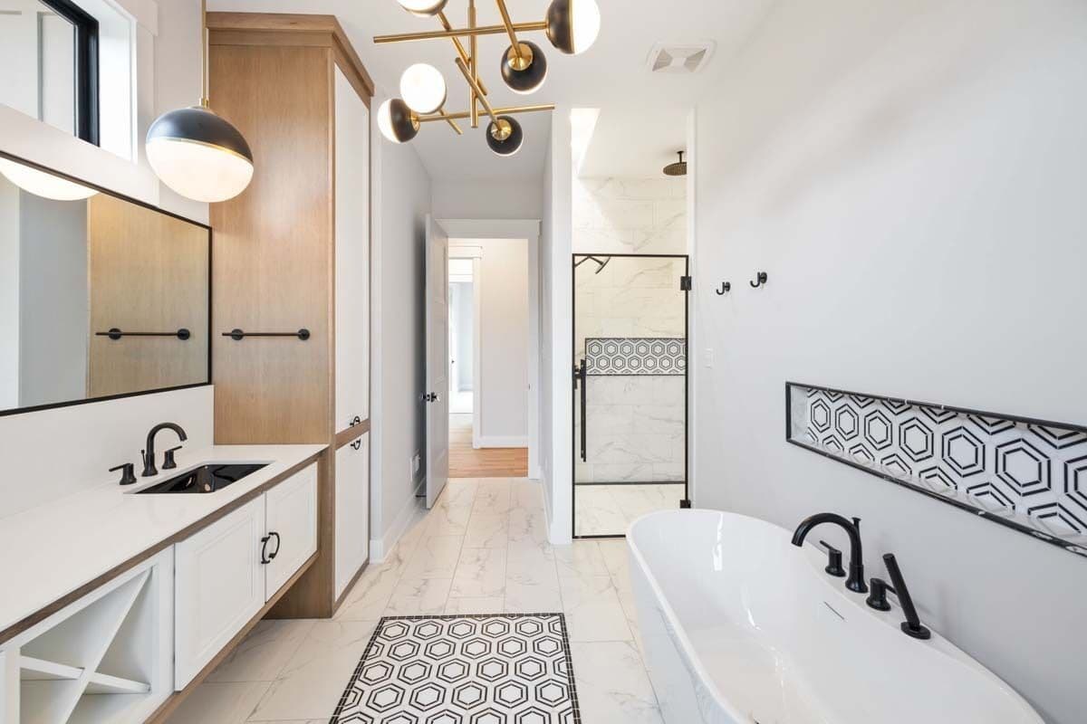 Primary bathroom with a dual sink vanity, a soaking tub, and a walk-in shower.