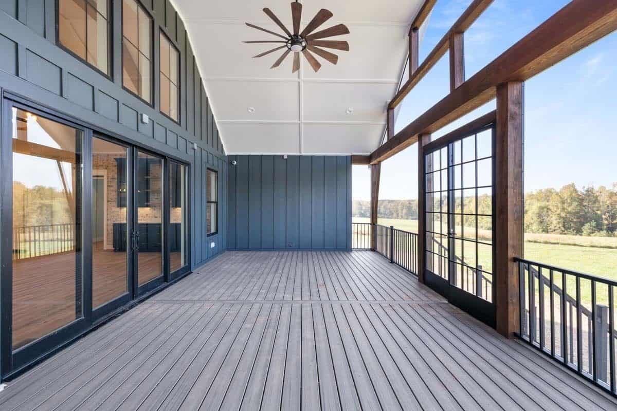 A vaulted ceiling mounted with a fan crowns the screened porch.