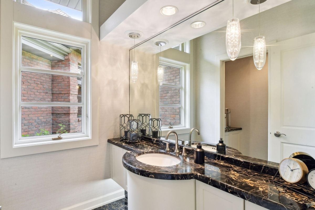 Bathroom with a sink and a large mirror.