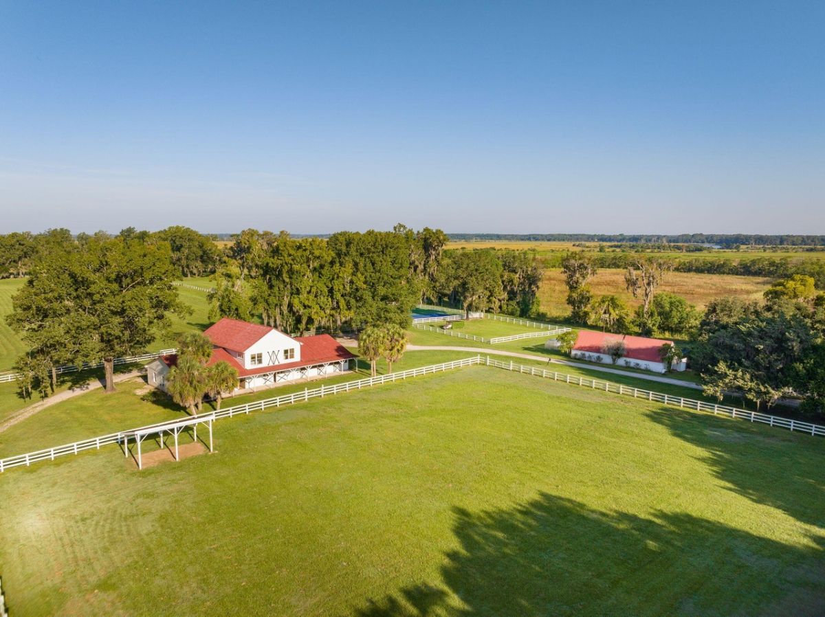 Aerial view of the barn with white fence.