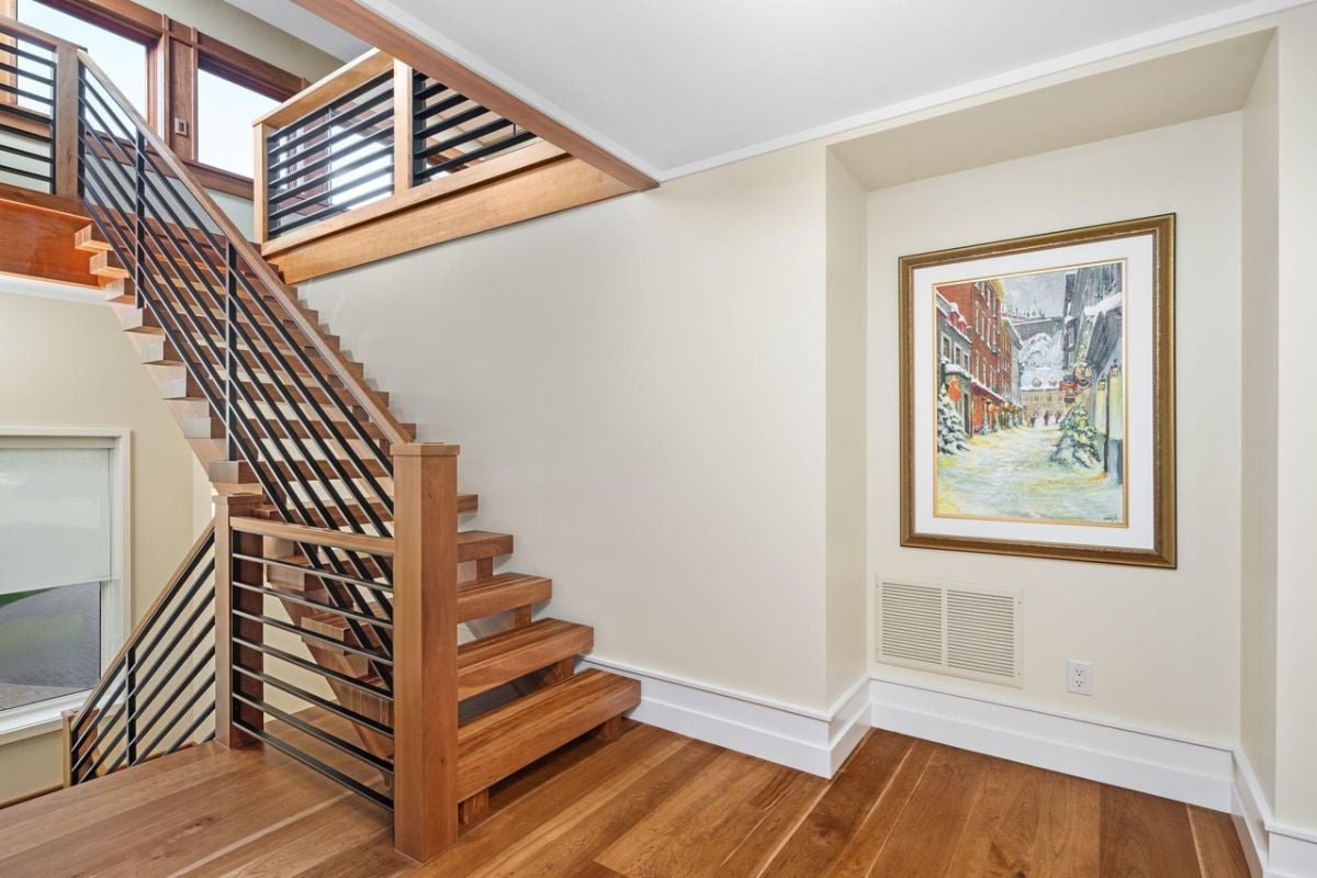 Staircase with wooden steps and metal railings.