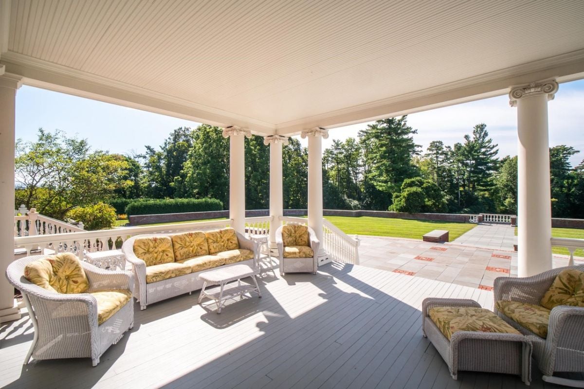 Patio with a couch and chairs.