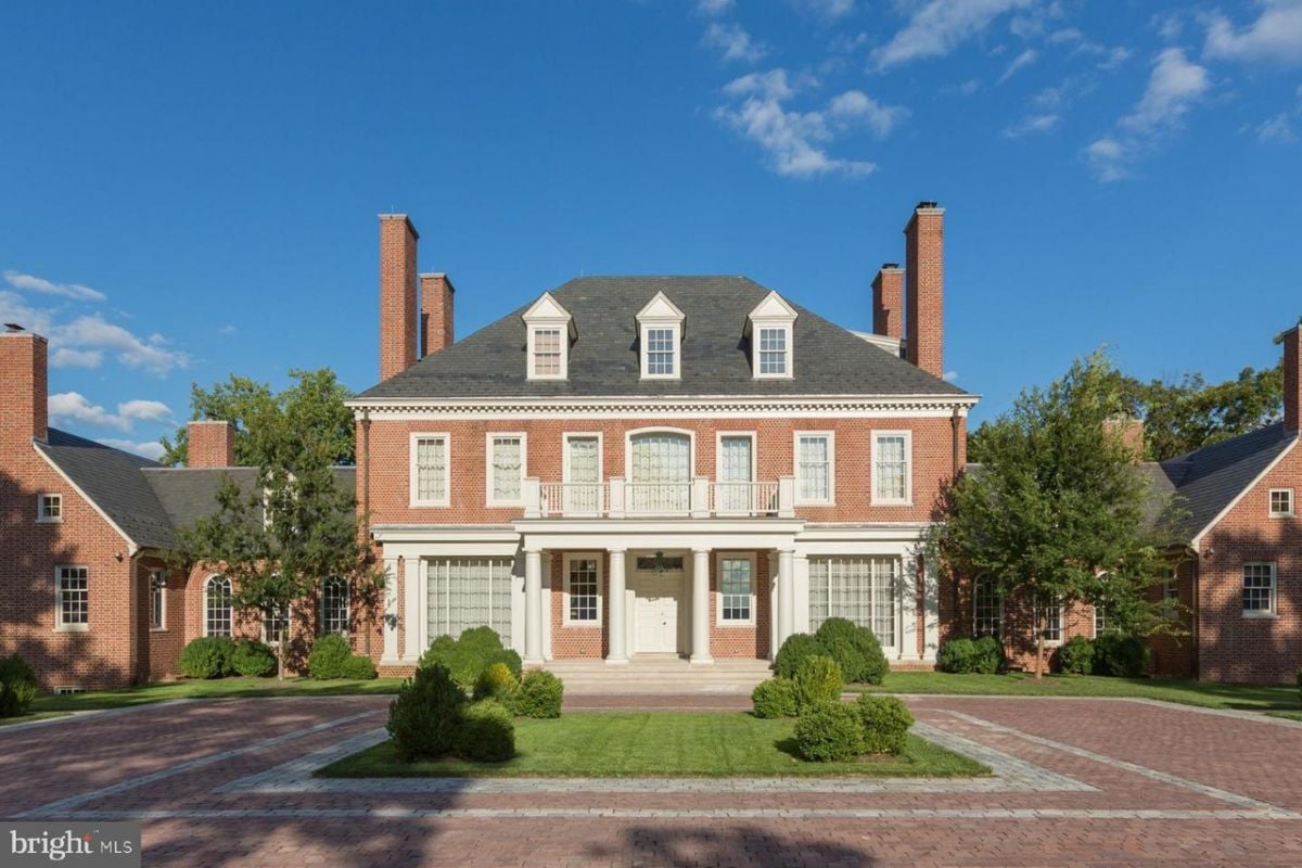 Front view of the mansion with spacious driveway.