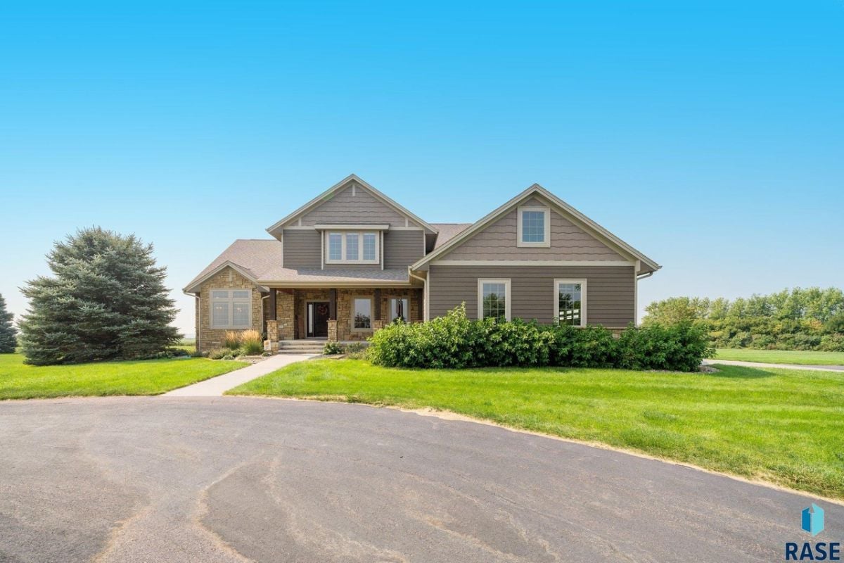 Front view of the house with a large green lawn.