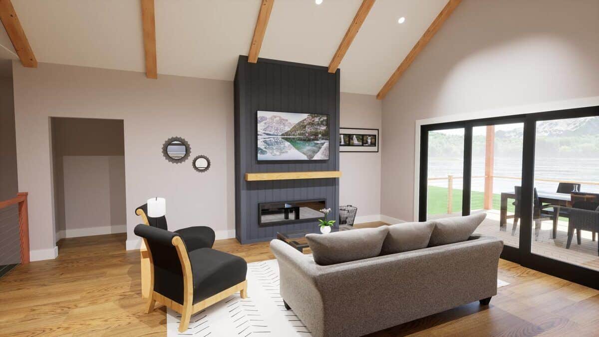 Living room with modern seats, a fireplace with a TV on top, and sliding glass doors that open onto a covered deck.