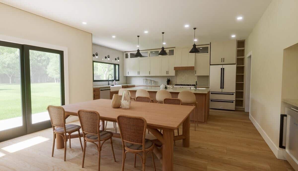 Dining area and kitchen with hardwood flooring and sliding glass doors that open onto the rear patio.