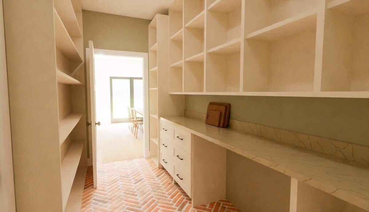 Walk-in pantry with built-in shelves, a marble counter, and terracotta flooring.