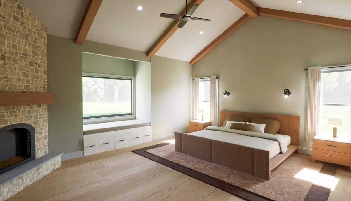 Primary bedroom with wooden furnishings, a window seat, and a stone fireplace.