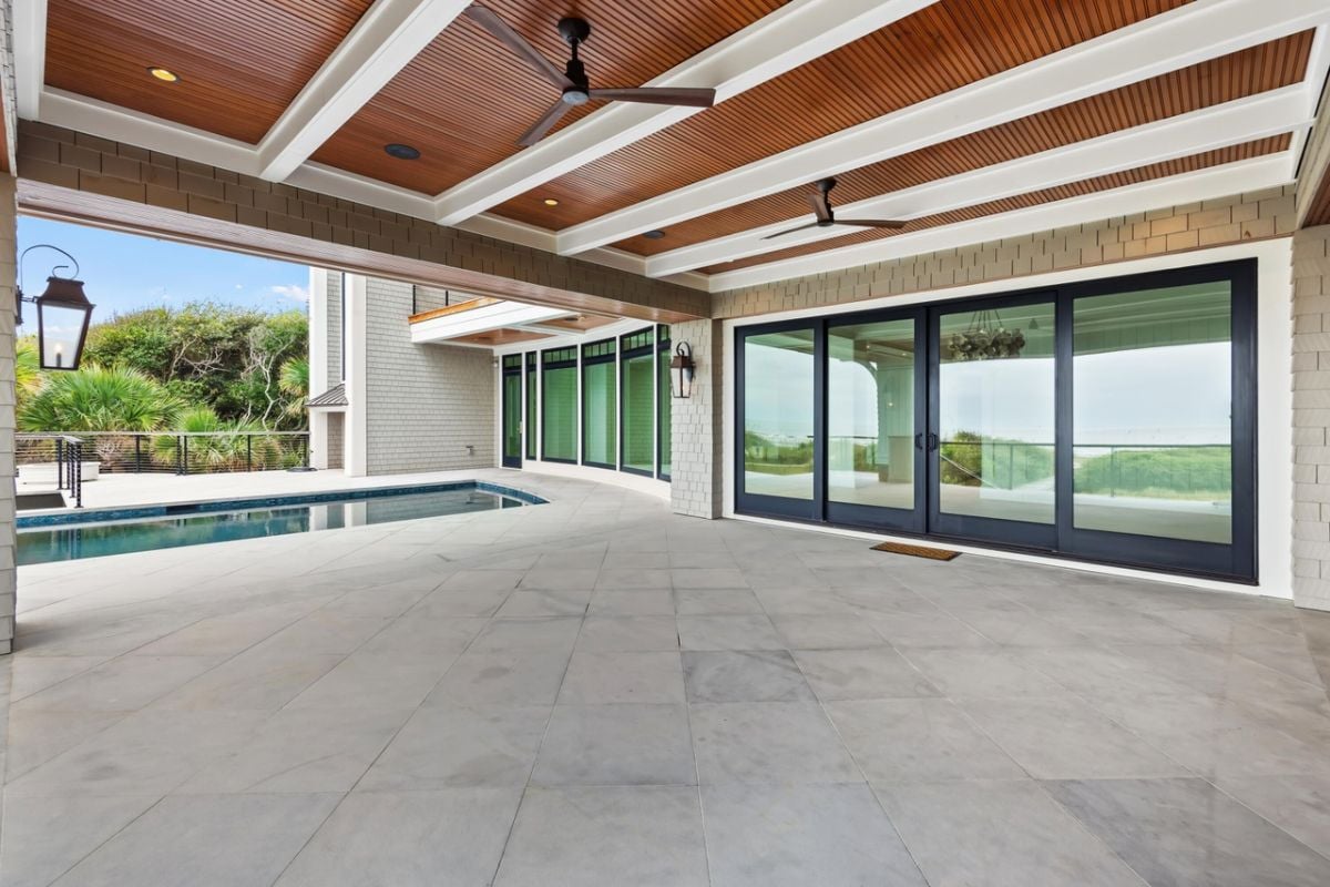 Covered patio with vaulted ceilings and ceiling fans.