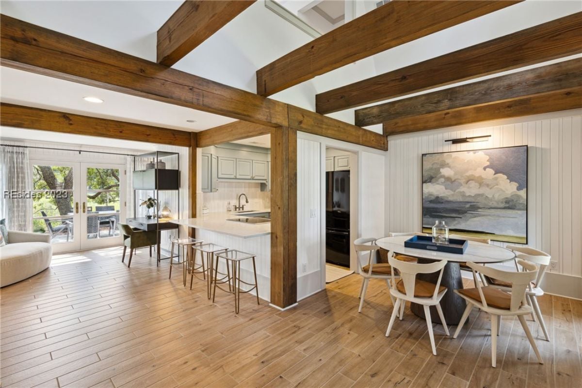 Dining room with vaulted ceiling, a table and chairs.