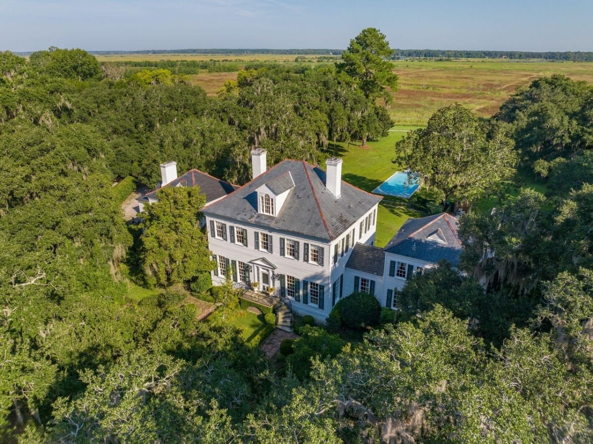 Aerial view of the mansion surrounded by trees.