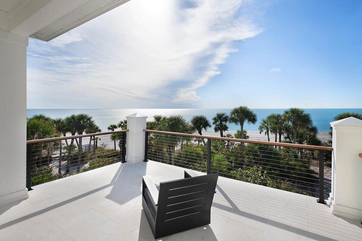 Covered deck with concrete flooring, metal railings, and spectacular views of the surrounding landscape.